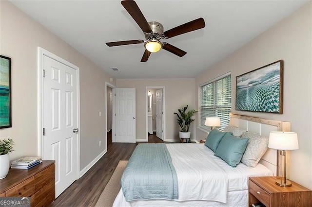 bedroom with ceiling fan, dark hardwood / wood-style flooring, and ensuite bathroom