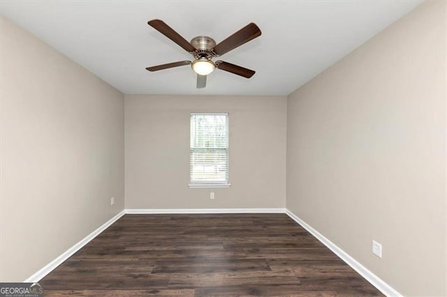 spare room with ceiling fan and dark wood-type flooring