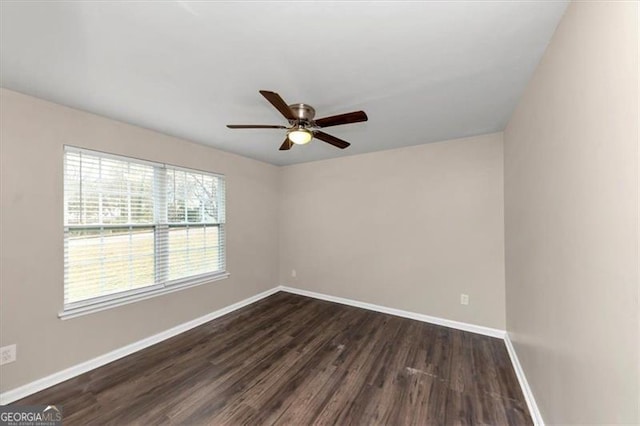 empty room with ceiling fan and dark wood-type flooring