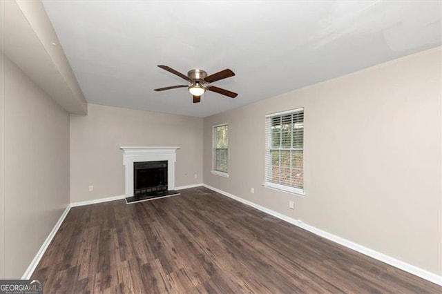 unfurnished living room with dark hardwood / wood-style floors and ceiling fan