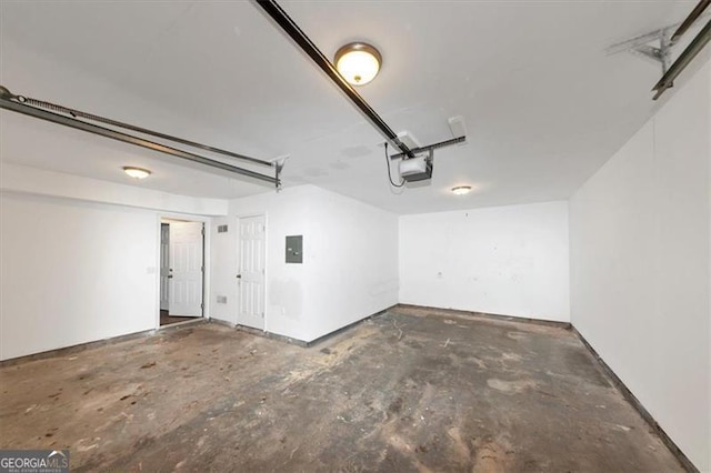 garage featuring electric panel and a garage door opener