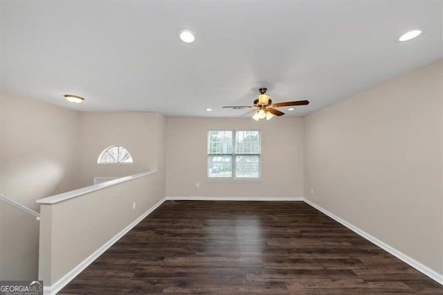 empty room with dark hardwood / wood-style floors and ceiling fan