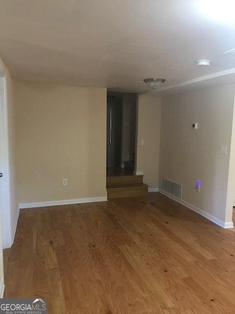 unfurnished room with wood-type flooring