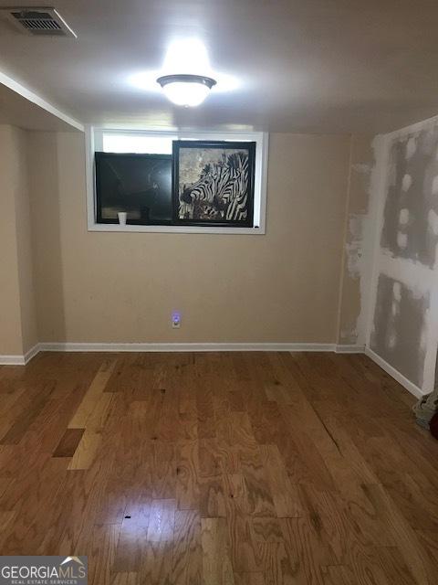 unfurnished room featuring hardwood / wood-style floors