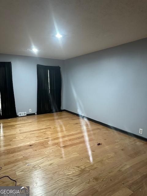 unfurnished room with light hardwood / wood-style flooring