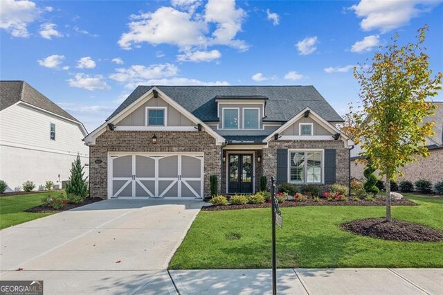 craftsman inspired home with french doors, a front yard, and a garage