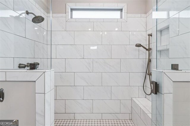 bathroom featuring tile patterned floors, walk in shower, and vanity