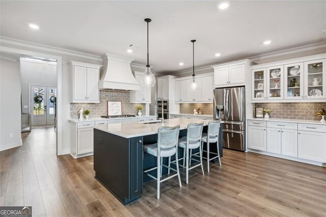 living room with hardwood / wood-style floors, a stone fireplace, beamed ceiling, a chandelier, and coffered ceiling