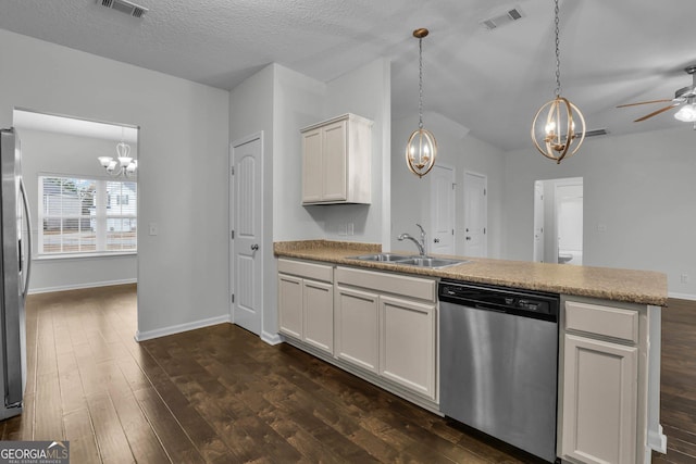 kitchen with pendant lighting, sink, white cabinets, and stainless steel appliances