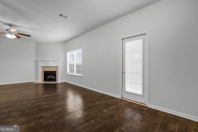 unfurnished living room with ceiling fan and dark hardwood / wood-style flooring