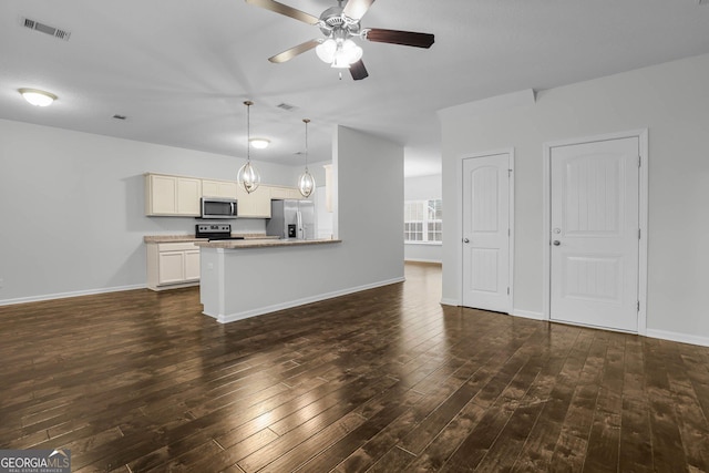 unfurnished living room featuring dark hardwood / wood-style flooring and ceiling fan