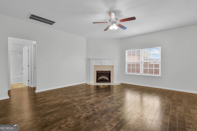 unfurnished living room with dark hardwood / wood-style floors and ceiling fan