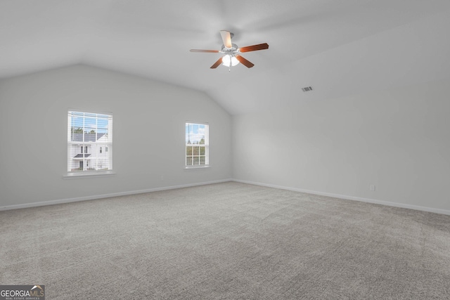 additional living space featuring carpet floors, vaulted ceiling, and ceiling fan