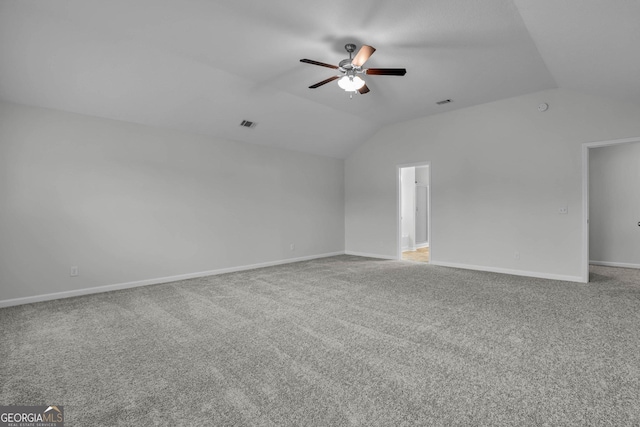 unfurnished room with carpet floors, vaulted ceiling, and ceiling fan