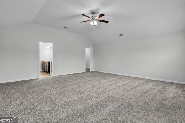 empty room featuring ceiling fan, light carpet, and lofted ceiling