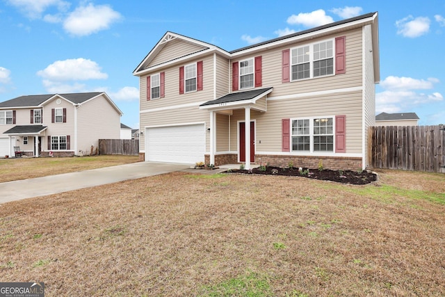 front facade featuring a front yard and a garage