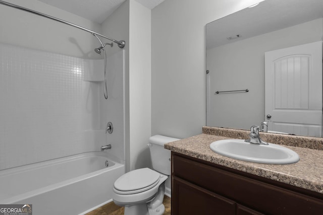 full bathroom featuring washtub / shower combination, vanity, and toilet