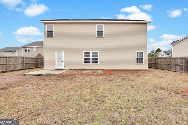 back of property featuring a yard and a patio