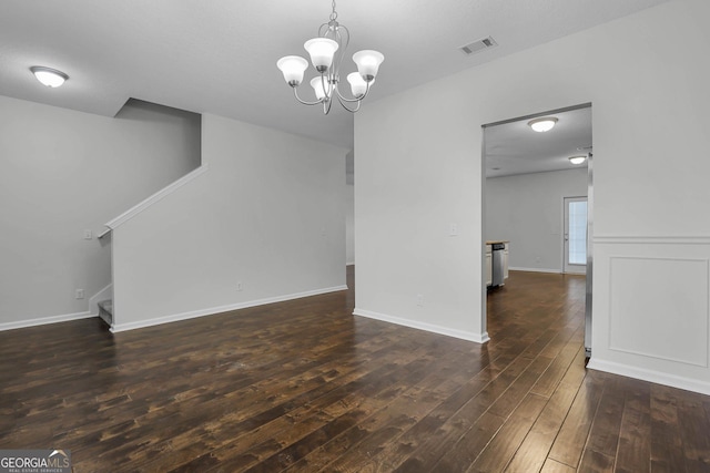 interior space featuring dark hardwood / wood-style floors and an inviting chandelier