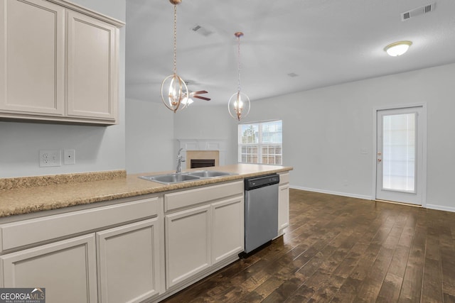 kitchen featuring dark hardwood / wood-style flooring, ceiling fan, sink, pendant lighting, and dishwasher