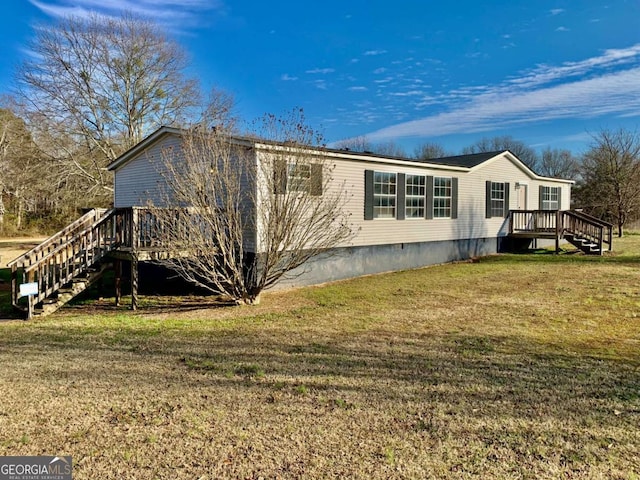 view of side of home featuring a deck and a lawn