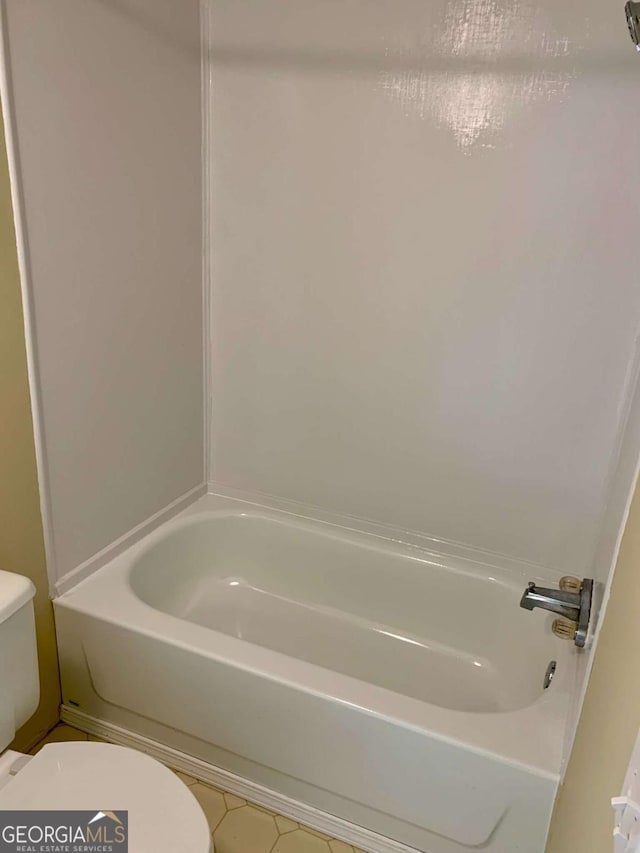 bathroom with toilet and a bath