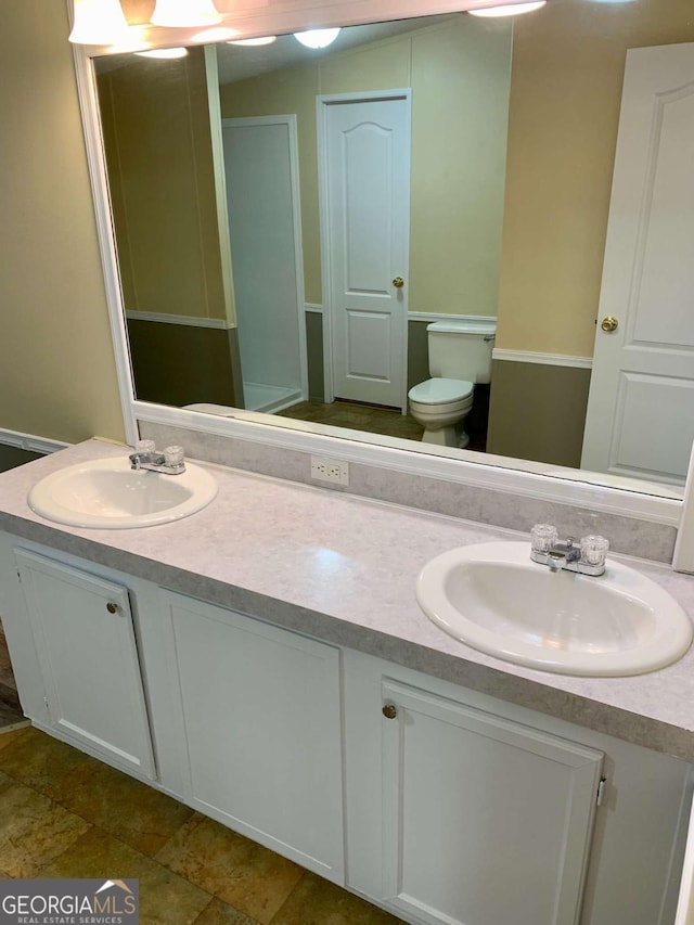 bathroom featuring vanity and toilet