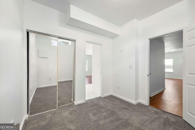 unfurnished bedroom featuring dark colored carpet