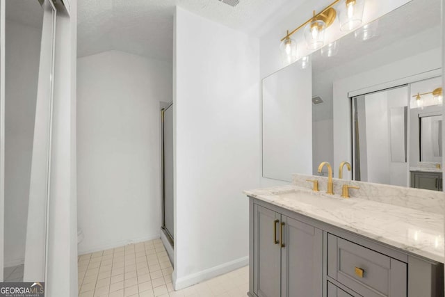 bathroom featuring a textured ceiling, vanity, and an enclosed shower