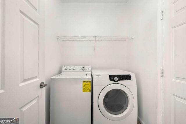 clothes washing area with washing machine and clothes dryer