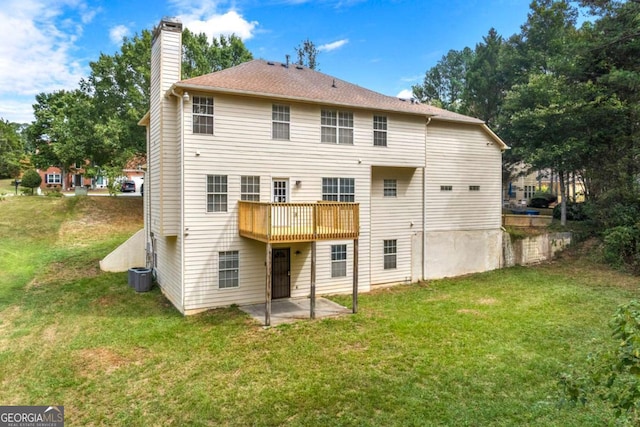 back of house featuring central AC, a yard, a wooden deck, and a patio