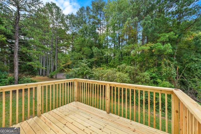 wooden terrace featuring a yard