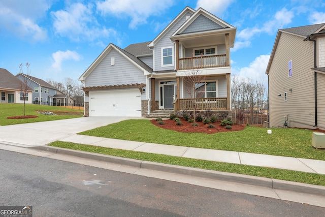 craftsman inspired home with a porch, a balcony, a front lawn, and a garage