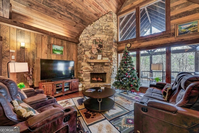 living room featuring wood ceiling, wood-type flooring, a stone fireplace, wood walls, and high vaulted ceiling