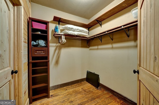 spacious closet featuring hardwood / wood-style floors