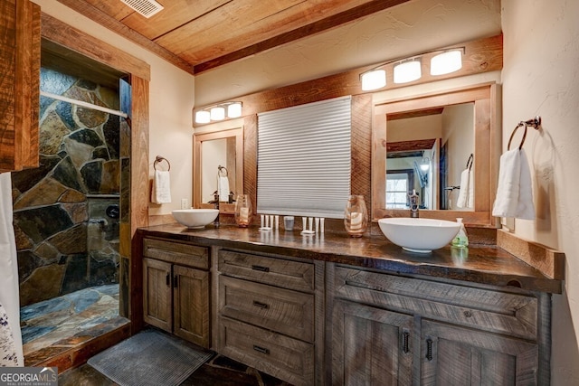 bathroom featuring a shower with shower door, vanity, and wood ceiling