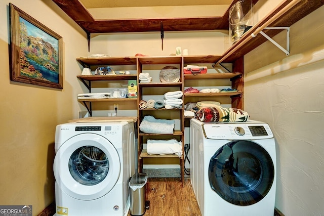 laundry area featuring washer and dryer and hardwood / wood-style flooring