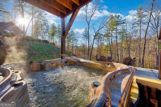 view of pool with a hot tub