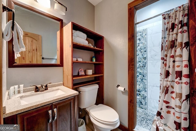 bathroom with toilet, vanity, and curtained shower