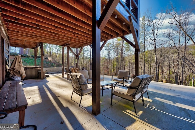 view of patio with an outdoor hangout area and a hot tub