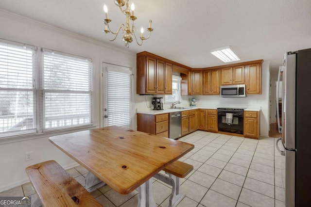 kitchen with hanging light fixtures, light tile patterned floors, a chandelier, and appliances with stainless steel finishes