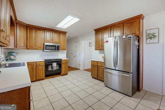 kitchen featuring light tile patterned floors, stainless steel appliances, ornamental molding, and sink