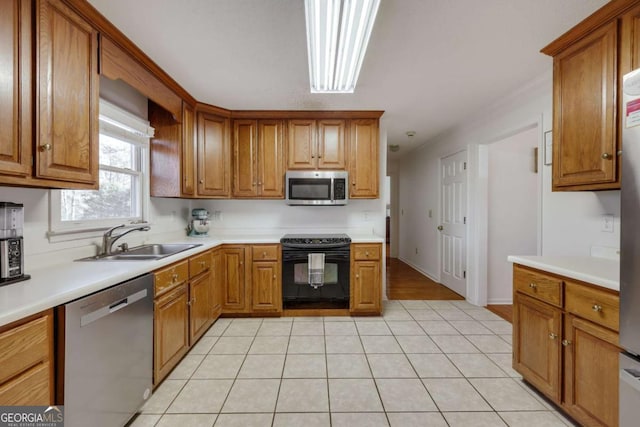 kitchen featuring sink, light tile patterned flooring, and stainless steel appliances