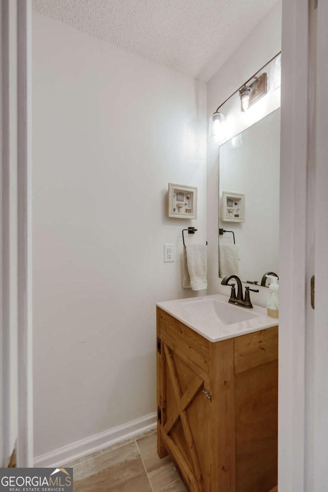 bathroom featuring vanity and a textured ceiling