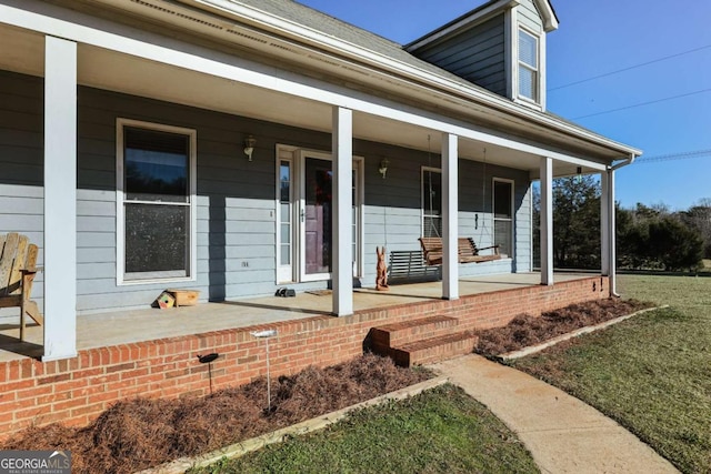 doorway to property featuring covered porch