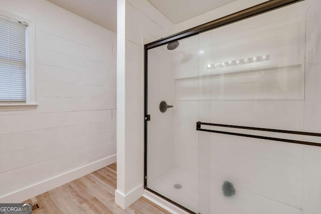 bathroom featuring wood-type flooring and walk in shower