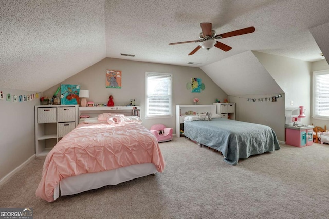 carpeted bedroom featuring vaulted ceiling, ceiling fan, and a textured ceiling