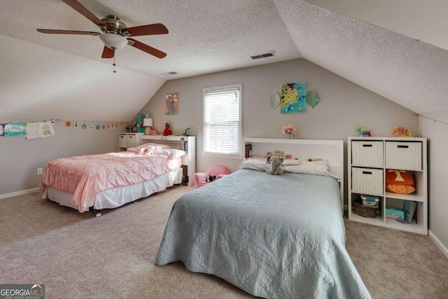 carpeted bedroom featuring ceiling fan, a textured ceiling, and vaulted ceiling