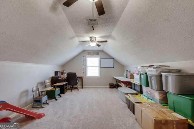 home office featuring ceiling fan, light colored carpet, and vaulted ceiling