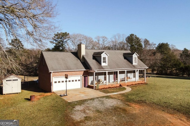 new england style home with a porch, a storage unit, a garage, and a front lawn